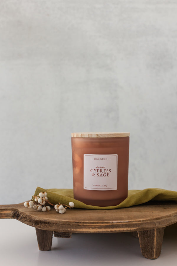 Earthy Cypress & Sage soy candle in 10 oz jar with palo santo and patchouli