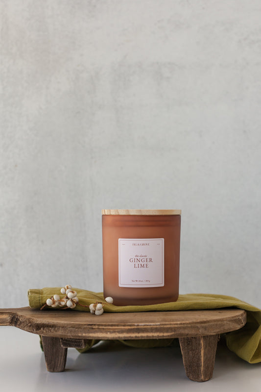 Ginger Lime candle by Fig & Grove, featuring a minimalist label and natural soy wax, with calming scents of ginger and lime essential oils.