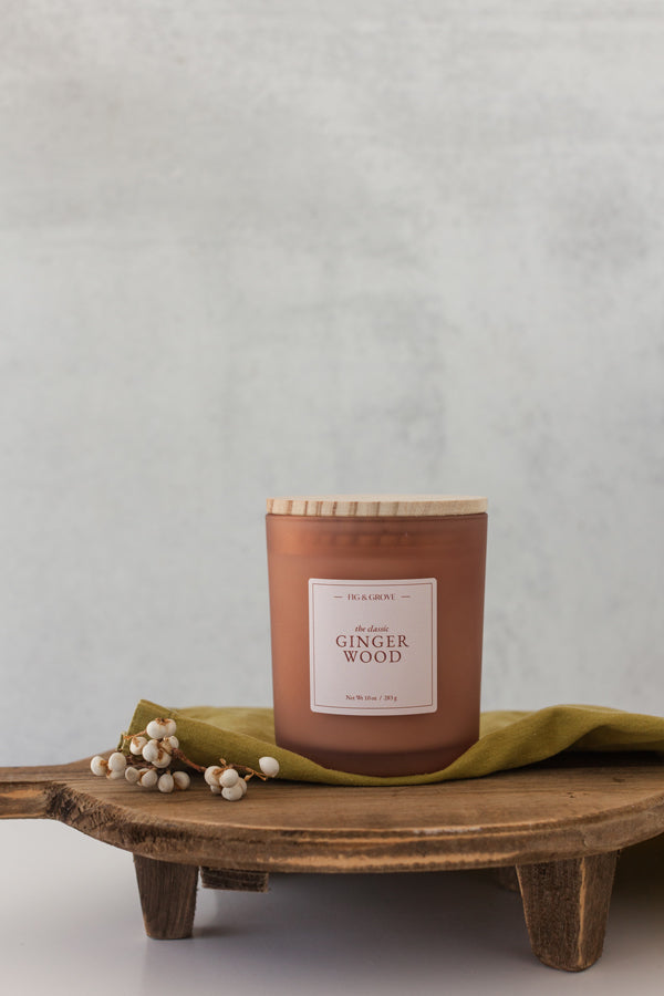 Gingerwood soy candle with warm ginger and palo santo in 10 oz jar.