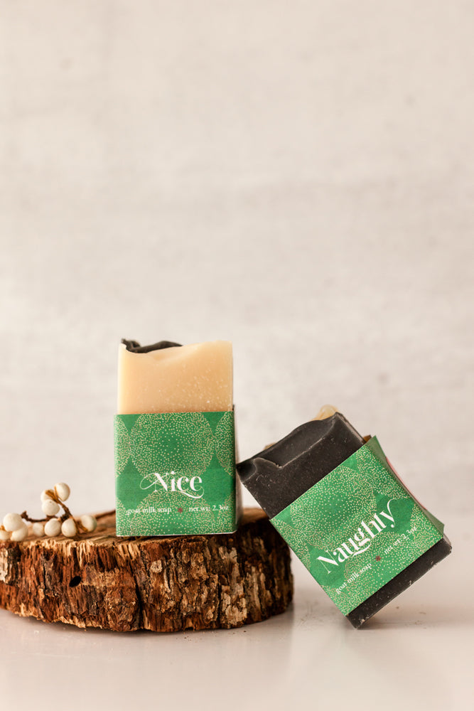 Naughty & Nice mini soap duo — one white, one black — wrapped together with Fig & Grove label, photographed on neutral background.