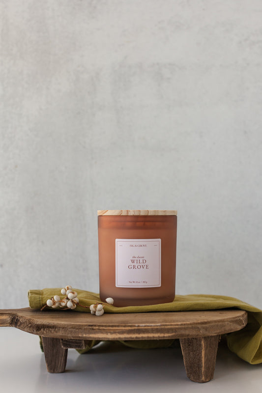 Wild Grove candle by Fig & Grove, featuring a minimalist label and natural wax, with calming scents of palo santo, lavender, and sage.