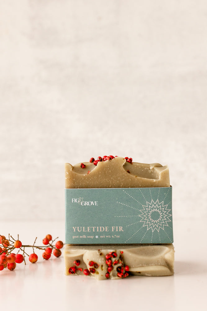 Close-up of Yuletide Fir soap with red berries – Fig & Grove winter soap