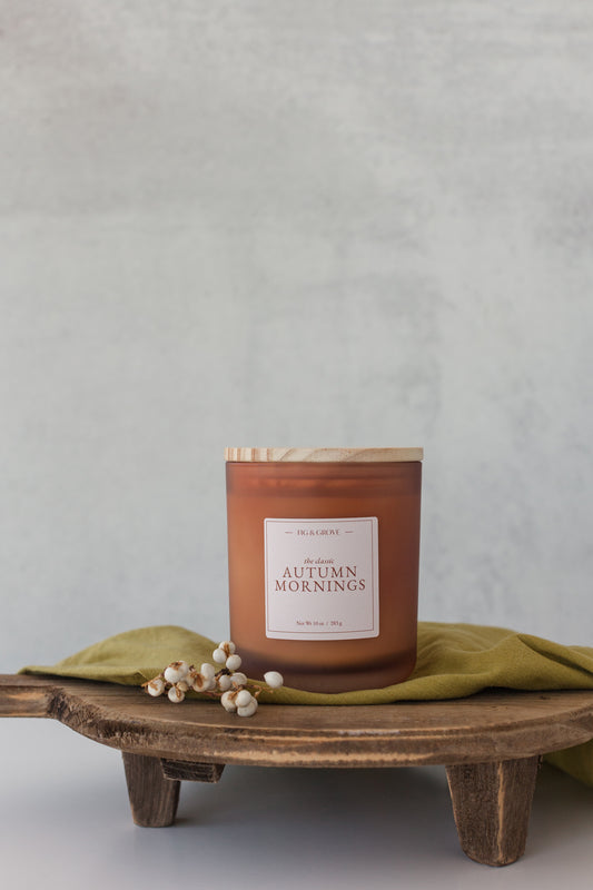 Autumn Mornings soy candle with orange, cinnamon, nutmeg, and clove essential oils – cozy fall home fragrance.