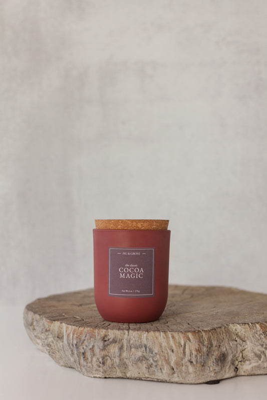 Cocoa Magic candle in umber glass jar on neutral background, evoking cocoa and coffee tones – Fig & Grove