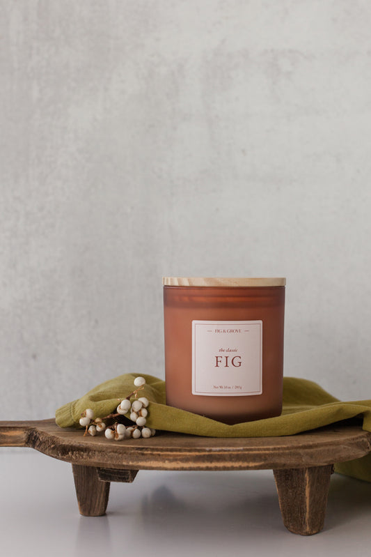Fig candle in brown glass jar with white berries, evoking sweet figs and warm spices – Fig & Grove