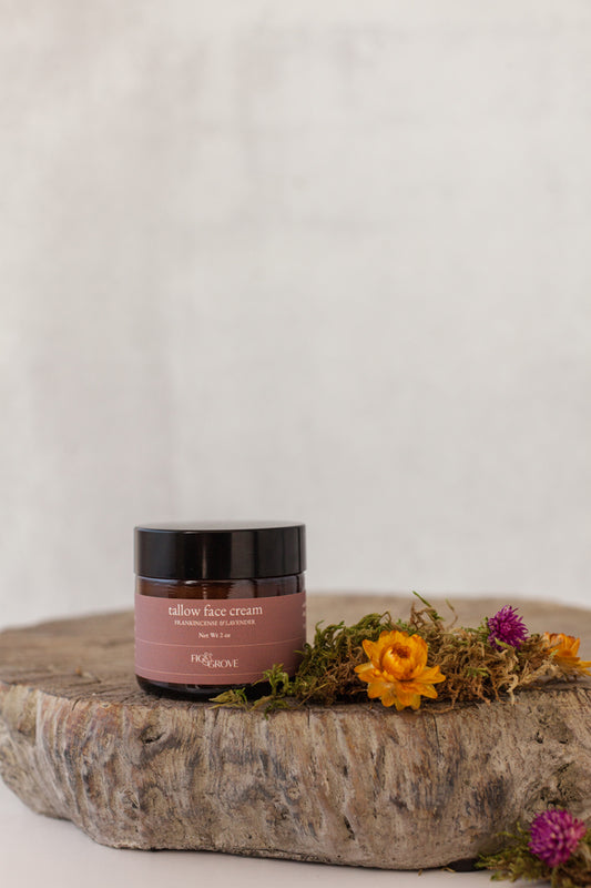 Tallow face cream with frankincense essential oil in a 2 oz amber jar