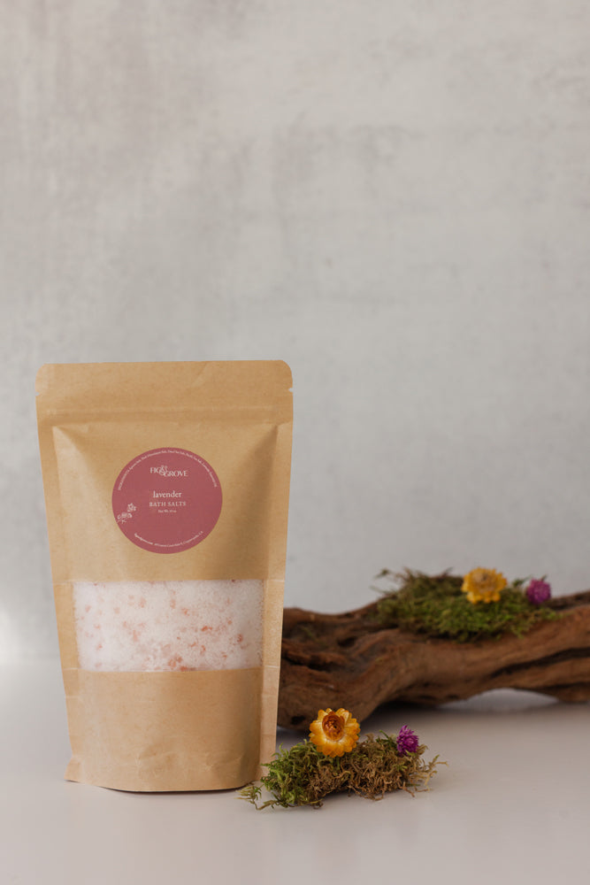 Lavender bath salts in a Kraft resealable pouch with a pink label on a neutral background with decorative elements - Fig & Grove