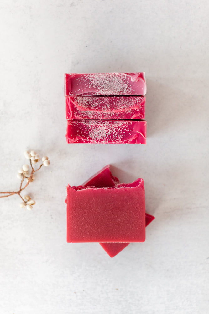 Winterberry handmade soap bar with a bright, cranberry hue and sea salt on top – Fig & Grove cranberry and lime scent
