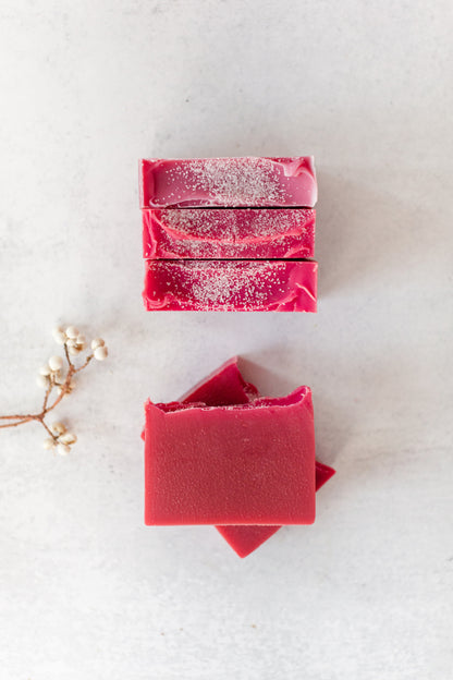 Winterberry handmade soap bar with a bright, cranberry hue and sea salt on top – Fig & Grove cranberry and lime scent